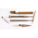 A silver and mother of pearl handled trowel form page marker, three propelling pencils, and a gold p