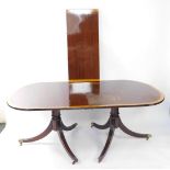 A Georgian style mahogany and yew wood cross banded twin pedestal dining table, with one additional