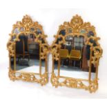 A pair of Belgian rococo style gilt wall mirrors, with seed scroll and floral decoration, 144cm high