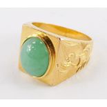 A Chinese gold and cabochon jade set gentlemen's signet ring, the shoulders engraved with a phoenix