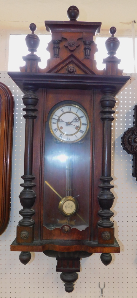 A Continental late 19th Century walnut cased wall clock, brass and enamel dial bearing Roman numer