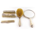 A George V silver backed hand mirror and clothes brush, Birmingham 1921, two silver backed clothes b