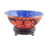 A Chinese Republic cinnabar lacquer bowl of lobed form with a blue interior, carved to the exterior