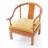 A Chinese teak horseshoe armchair, with a blue cushion seat.