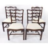 A set of four Chippendale style early 20thC mahogany ladder back single dining chairs, with drop-in