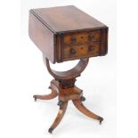 A Regency rosewood drop leaf work table, with two frieze drawers, raised on a U shaped support, over