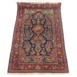 A fine Persian Kurk Kashan blue and red ground wool prayer rug, decorated with a twin columned templ