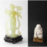 A Chinese 20thC jadeite figure of a lady, modeled standing in billowing robes, holding a flower, rai