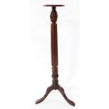 A Victorian mahogany jardiniere stand, with fluted and foliate carving, raised on three cabriole leg