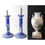 A pair of Wedgwood late 19thC dark blue Jasper candlesticks, sprigged with classical figures, 22cm h