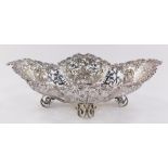 An Edwardian silver basket, of pierced quatre lobe form, embossed with flowers, leaves and rococo sc