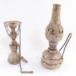 An Egyptian silver oil lamp, with pierced and engraved foliate decoration, 22.5cm high, and a silver
