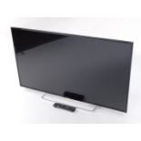 A Panasonic 49" LCD TV, model number TX-49ES503B, with remote.