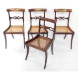 A set of three Regency rosewood and brass inlaid single dining chairs, with cane seats, together