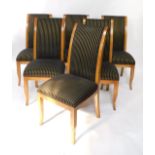 A set of six Reprodux pale oak Regency style dining chairs, with black and gilt striped over stuffed