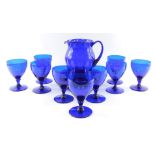 A set of nine Bristol type blue glass rummers, together with a blue glass water jug, and eight plate