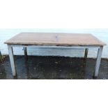 A rectangular slatted garden table, raised on sqaure legs, 75cm high, 179cm wide, 90cm deep.