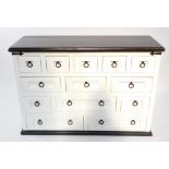 A black and white painted kitchen chest, with an arrangement of thirteen long and deep short drawers