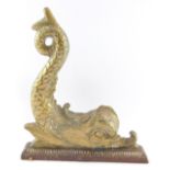 A Victorian brass and cast iron door stop, cast as a dolphin, 21cm high, 26cm wide.