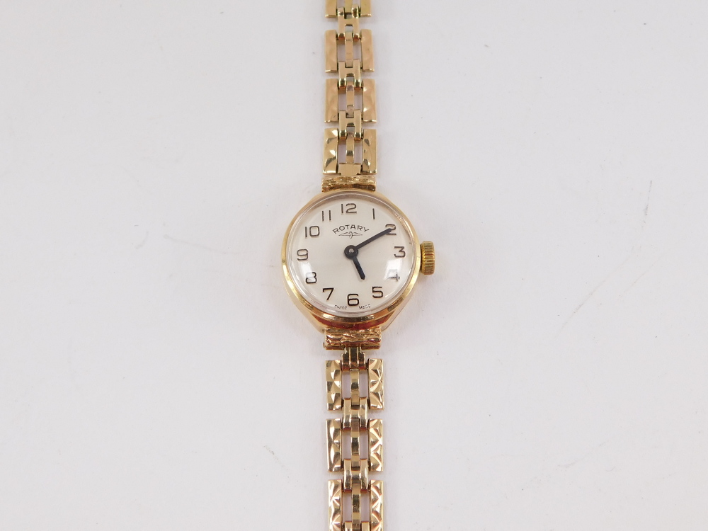 A Rotary lady's 9ct gold cased wristwatch, champagne dial bearing Arabic numerals, on a gold three b