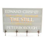 A painted wood and metal wall mounted coat rack, the rectangular panel board painted with "Edward Cr