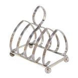 A George V silver four division toast rack, raised on ball feet, W Hutton &Sons Ltd, Birmingham 1914