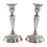 A pair of Victorian loaded silver Adam style candlesticks, of fluted oval form, William Aitken, Ches