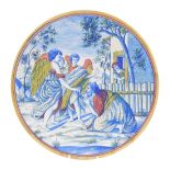 An Italian late 19thC maiolica charger, painted with a kneeling figure supplicating himself before t