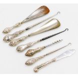 A group of silver handled button hooks and shoe horns. (a quantity)