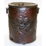 An Arts and Crafts copper coal bucket, in a design of heads of dragons, with two ring handles, on th