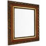 An early 20thC wall mirror, with rectangular mirror plate, with outer oak border and gilt twist flor