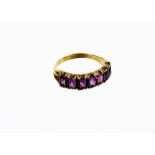 An amethyst set dress ring, of half hoop design with oval cut amethyst in claw setting with V splaye