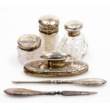 A group of silver mounted dressing table items, to include three silver topped cut glass jars, a sil
