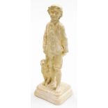 A plaster figure of a boy walking a dog, marked REG79, on a rectangular base, 36cm high.