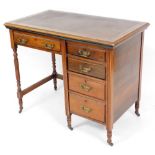 An Edwardian walnut console desk, with brown leather inset top above single drawer with four drawer