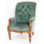 A Victorian button back armchair, in green draylon with walnut framed and reeded supports, 105cm hig