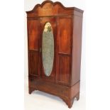 An Edwardian mahogany double wardrobe, with moulded cornice top, inlaid with marquetry neoclassical