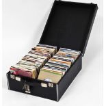 A cased set of 45 rpm records, mixed genres, to include Bucks Fizz, Enigma, John Lennon, Polydor Rec