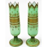 A pair of Victorian vaseline glass vases, in green with gilt top, 34cm high.