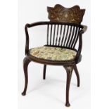 An Edwardian inlaid elbow chair, with slated back and carved shield crest with parquetry detailing o