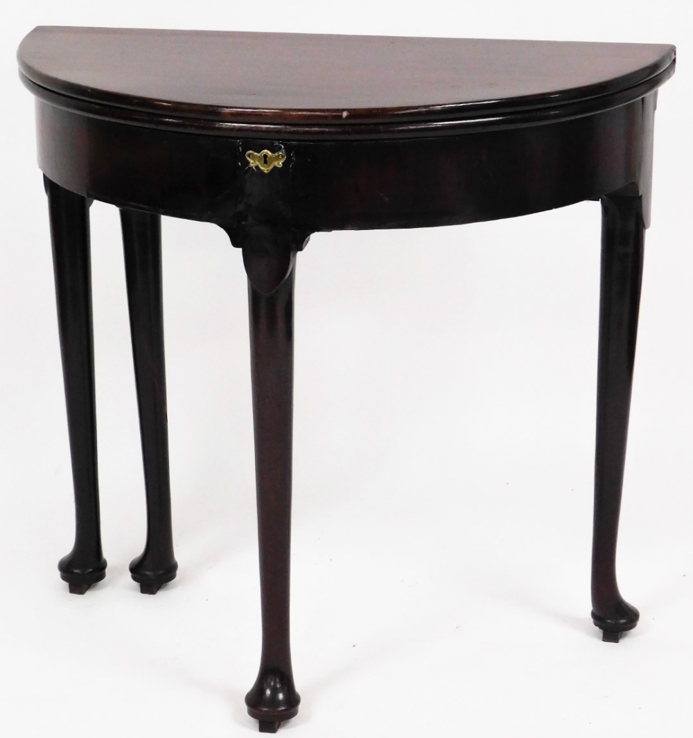 An 18thC mahogany demi lune tea table, with fold over top on pad feet with brass escutcheon, 75cm hi