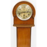 A 1950s walnut grandmother clock, with silvered dial, with arched top and fret work detailing, eight