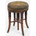 A Victorian mahogany piano stool, the floral upholstered top on four out splayed legs, 44cm high, 32