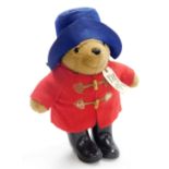 A Paddington Bear, with blue hat and red duffel coat with black wellingtons, 35cm high.