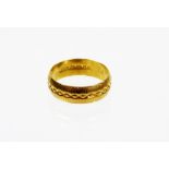 A 22ct gold wedding band, of hammered design, Sheffield assay, numbered 741, ring size M½, 4.2g.