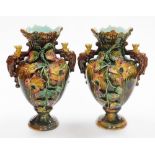 A pair of majolica Continental vases, each heavily encrusted with flowers, with flared rims, 31cm hi