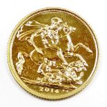 An Elizabeth II full gold sovereign, dated 2014, in plastic coin casing.