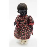 A Pedigree Afro Caribbean doll, in a floral dress, with cream shoes, 39cm high.