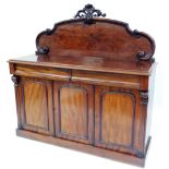 A Victorian mahogany sideboard, the carved panelled back above two drawers and three cupboard door s