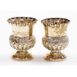 A pair of Edwardian silver thistle shaped vases, with floral crimped borders and embossed flower hea